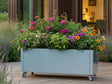 CUBY Pflanzkasten aus verzinktem Stahl auf Rollen mit bunten Blumen