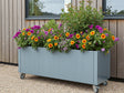 CUBY Pflanzkasten aus verzinktem Stahl mit Gartenblumen auf Rollen